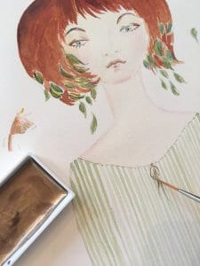 Man sieht eine Aquarellfarbe in Gold in einem kleinen Tiegel. Dazu ein junges MÃ¤dchen im Artdeco-Stil in pastellen GrÃ¼ntÃ¶nen. Das Bild wurde von der KÃ¼nstlerin Dodo Kresse gemalt.